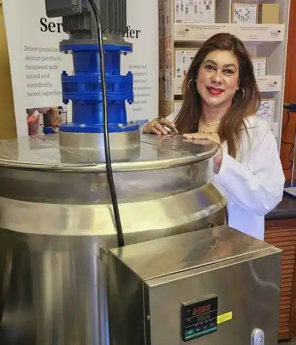 Clinical skin journalist and formulator with professional lab machinery at ShaRique Skin. mobile