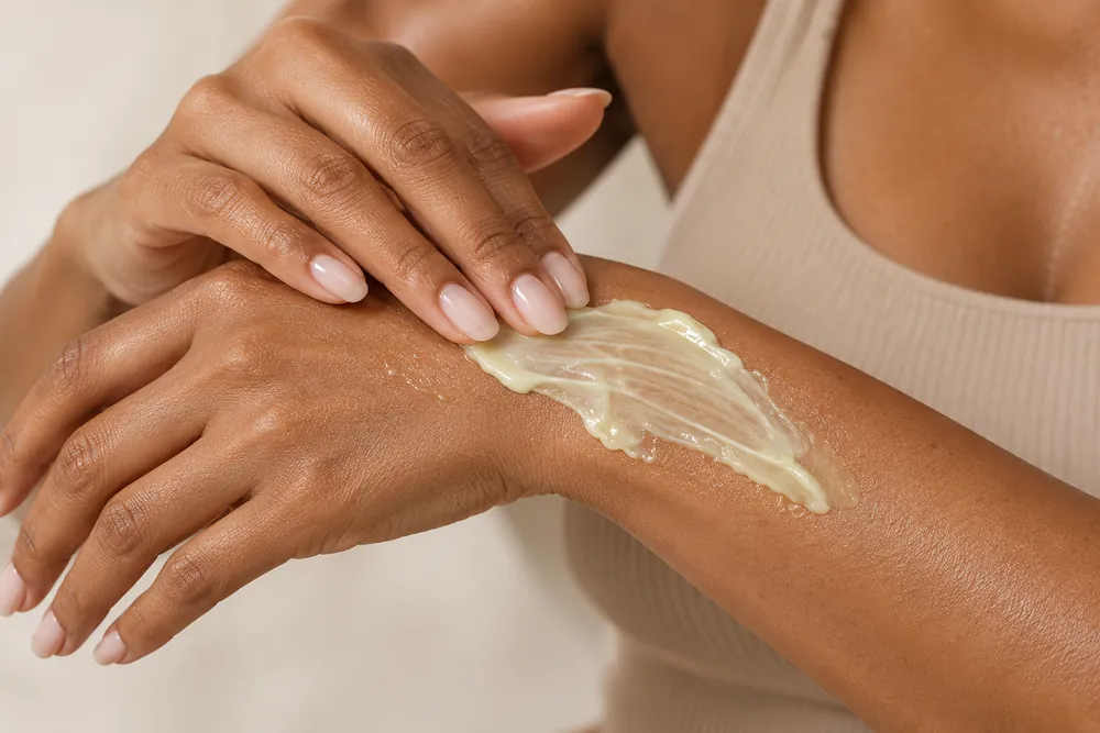 Smoothing retinol body cream over the hands, which show ageing first